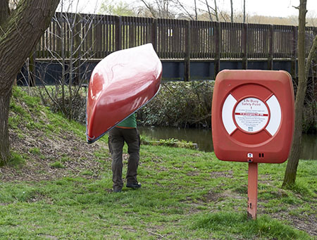 some bloke carrying a canoe for wildnerss weekend...